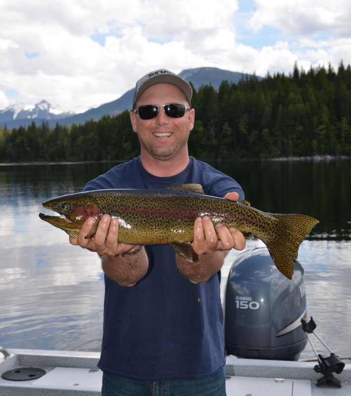 smiling man holding large fish